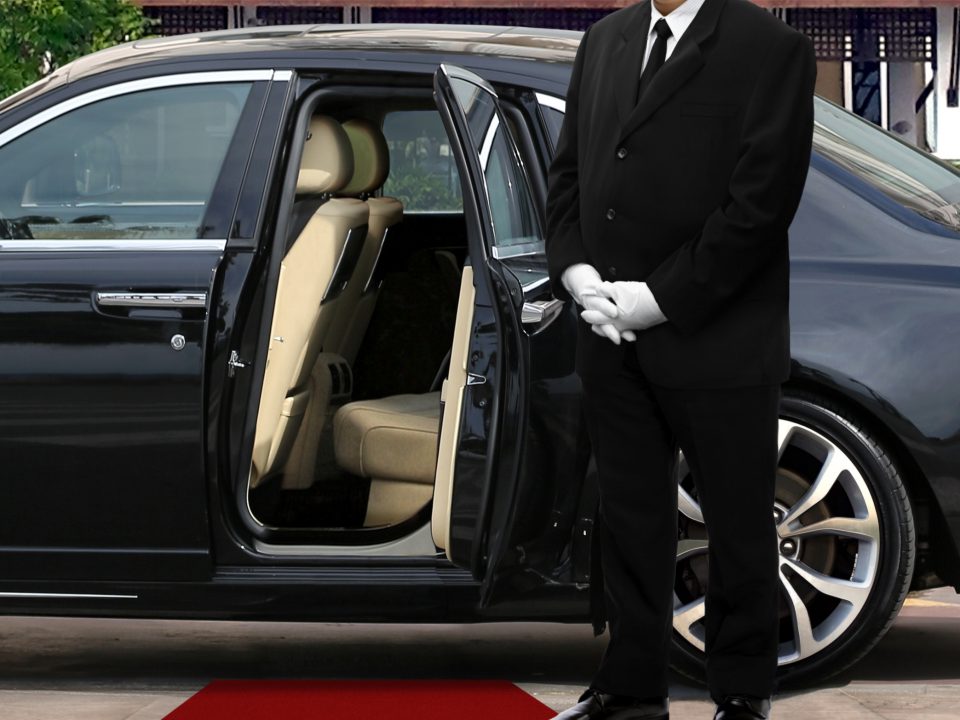 Limo,Driver,Standing,Next,To,Opened,Car,Door,With,Red